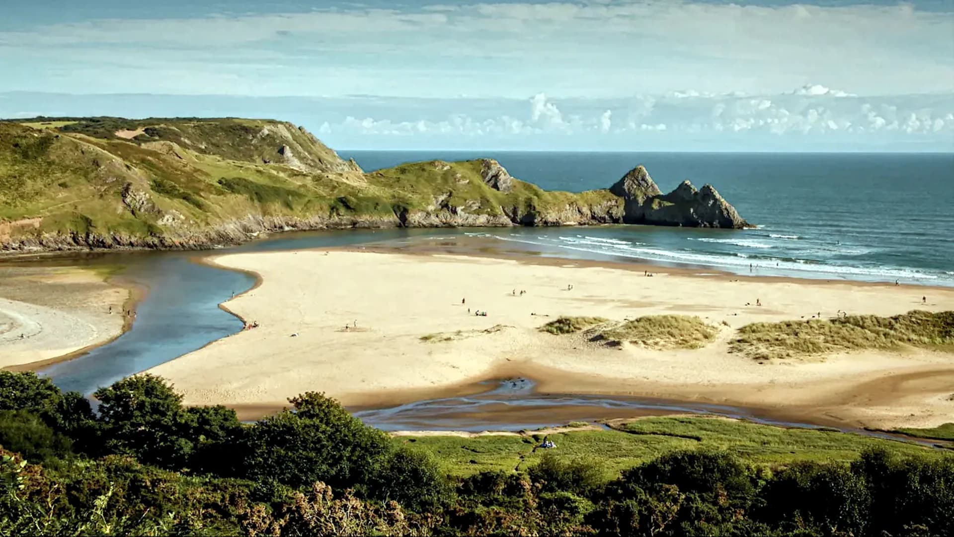 Three Cliffs Bay with its sandy beach, winding stream and coastal cliffs